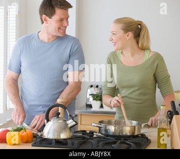 Couple cooking in kitchen Stock Photo