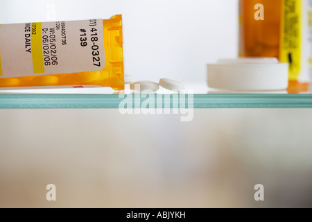 Medication bottle and pills on shelf Stock Photo