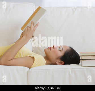 Woman reading on sofa Stock Photo