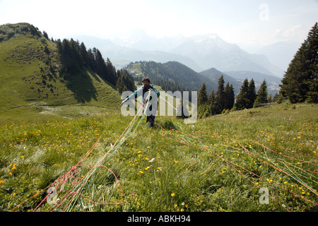 Paraglider preparing his chute for take off for a flight over Villars in Valais region of Switzerland Europe Stock Photo