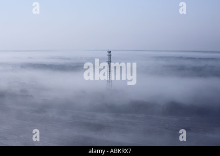 Aerial scenic photo of cell phone communication tower early morning in the fog Manatee county Florida Stock Photo