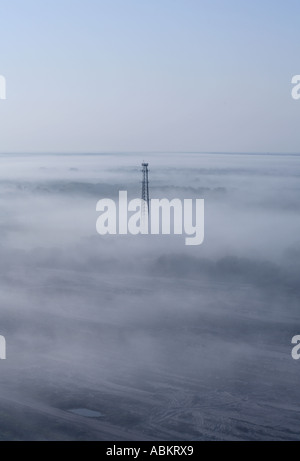 Aerial scenic photo of cell phone communication tower early morning in the fog Manatee county Florida Stock Photo