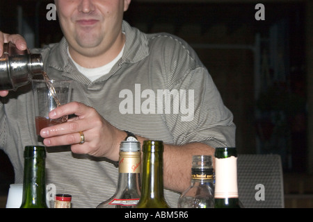 Happy bartender age 34 at cousins birthday party in the home. Chicago Illinois IL USA Stock Photo
