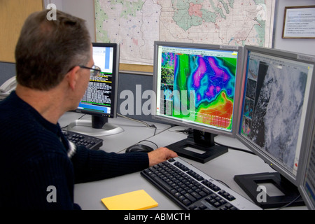 Meteorologist looking at weather maps with satellite data on computer screens at the National Weather Service in Boise Idaho Stock Photo