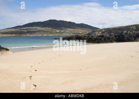 Woman leaving footprints in sand  Dog's Bay  Connemara  Ireland Stock Photo