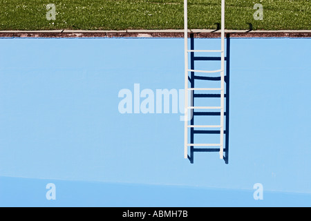 Ladder At Wall Of Empty Swimming Pool Stock Photo