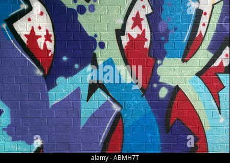 Colorful Graffiti spray painted on a brick wall Stock Photo