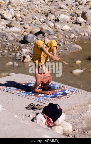 A man practicing yoga in small village Gangotri close to the source of Ganges river Stock Photo