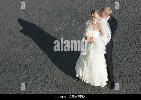 A portrait of a newly married couplle seen here embracing on their wedding day. Stock Photo
