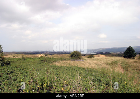 Kenfig Nature Reserve location of Kenfig castle near Porthcawl South Wales in the background is the Port Talbot Steel works Stock Photo