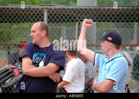 New softball umpires for ASA organization in USA and America during games and in pregame checking bats and lineups and rules and such for team games Stock Photo