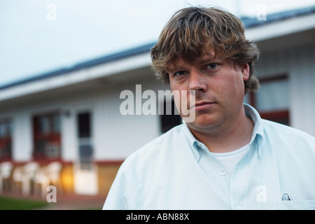 Portrait of Man in Front of Motel Stock Photo