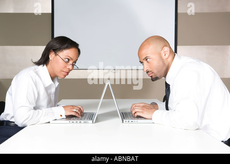 Businesspeople working at separate laptops Stock Photo