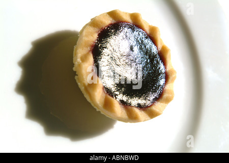 Jam tart on a white plate UK Stock Photo