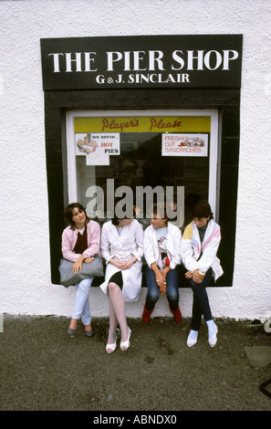 Scotland Argyll Inverary girls sat in shop window Stock Photo