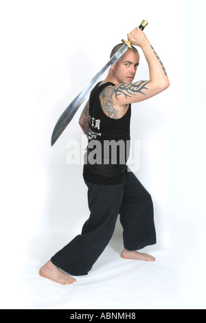 Muscled asian kung fu man in action pose with nunchucks. Blood s Stock  Photo by ©ysbrand 47487941