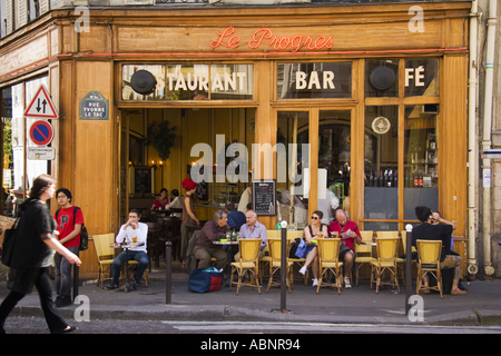 People at outdoor tables in front of Le Progres Restaurant Bar and Cafe on Rue Yvonne LeTac Monmartre Paris France Stock Photo