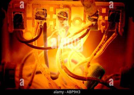 closeup of wires on timer connected to computer in glowing gold light Stock Photo