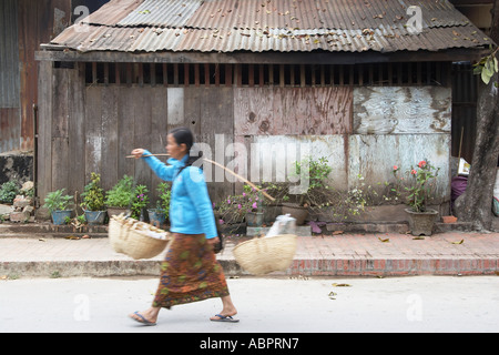 Woman Vendor Walking Along Road Stock Photo