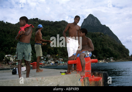Group of local boys on the harbor quay at Soufriere near the Pitons, St Lucia, West Indies Stock Photo