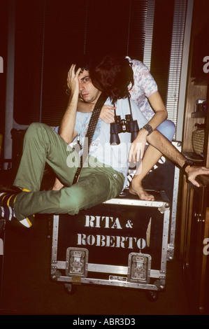 Brazil. Rita Lee & Roberto Carvalho on tour sitting on a flight case marked "Rita & Roberto" with guitar strap and binoculars. Stock Photo