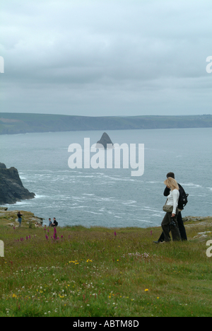 Young Couple Enjoying a Walk on Cliff Top at Tintagel Castle Cornwall England United Kingdom UK Stock Photo