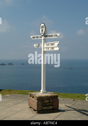 The Famous Signpost at Lands End with Longships Lighthouse in Background Cornwall England United Kingdom UK Stock Photo