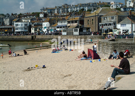 People Sitting on Beach at St Ives Cornwall Stock Photo