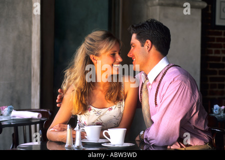 young attractive couple age 20s and 30s having coffee together in café laughing Stock Photo