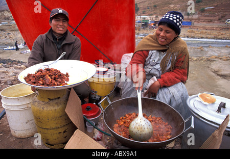 Preparing a local dish of meat and potatoes in a spicy sauce Fiesta de Chutillos Pilgrims from Potosi Bolivia South America Stock Photo