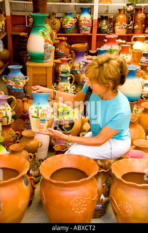 Tourist looking at pottery for sale of handmade artwork near Antigua Guatemala Stock Photo