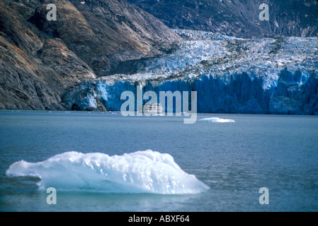 Iceberg and ship at Dawes Glacier Endicott Arm Bay Alaska AK SS Spirit of Discovery Cruise West Tours Stock Photo