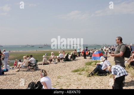 Crowds gathered on the beach at Stokes Bay to watch the International Fleet Review in the Solent in June 2005 Stock Photo