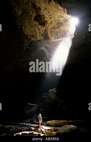 The Shaft of Light beaming onto a female tourist on the main entrance trail at Carlsbad Caverns New Mexico USA Stock Photo