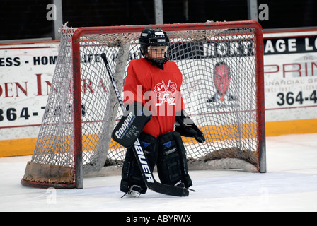 6 year old boy plays the position of goalie in a juvenile ice hockey program Stock Photo