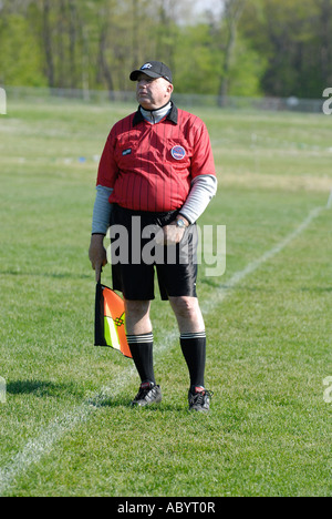 Male umpire controls Girls high school soccer action Stock Photo