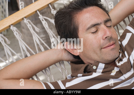 Man relaxing in hammock Stock Photo