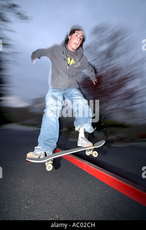 Young man performing trick on skateboard Stock Photo