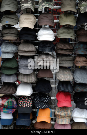 Display of men's caps of various designs and colours outside clothes shop Stock Photo