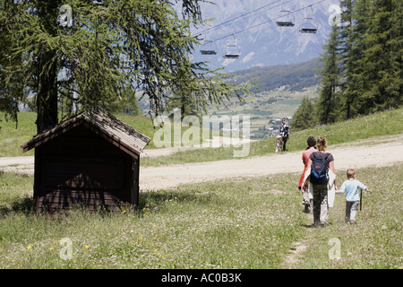 Tourists walking in a ski resort in summer Les Orres, Hautes Alpes, France Stock Photo