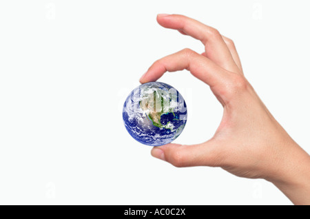 Womans fingers holding Earth close up digital composite Stock Photo