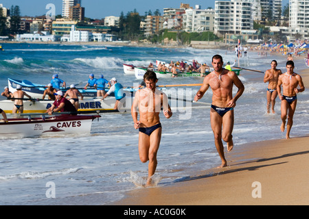 Surf lifesavers warm up for surfboat races on Cronulla Beach during the New South Wales Surf Lifesaving Championships Stock Photo