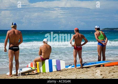 Lifesavers competing in rescue board races look out over the surf at Cronulla Beach at the New South Wales Lifesaving Champions Stock Photo