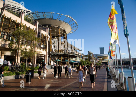 People stroll along the waterfront beside the bars and reataurants of Cockle Bay Wharf in Darling Harbour Sydney Stock Photo