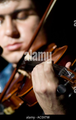 a very talented fiddle player playing folk music Stock Photo