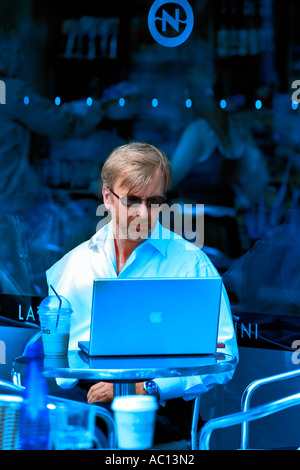 Businessman uses his laptop while having a coffee break Stock Photo