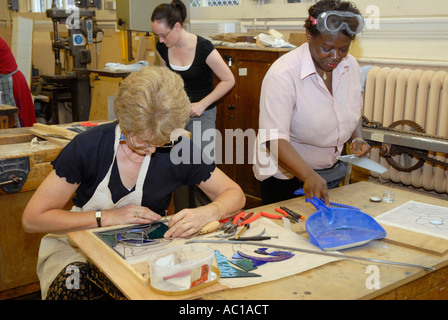 Adult education evening class in stain glass making. Stock Photo