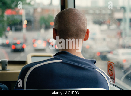 Young lad looking out of front upstairs window of double decker bus London Stock Photo