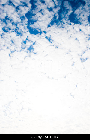 very bright white clouds in back lit and a bit of blue sky Stock Photo