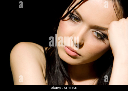 Dark-haired woman hand to head Stock Photo